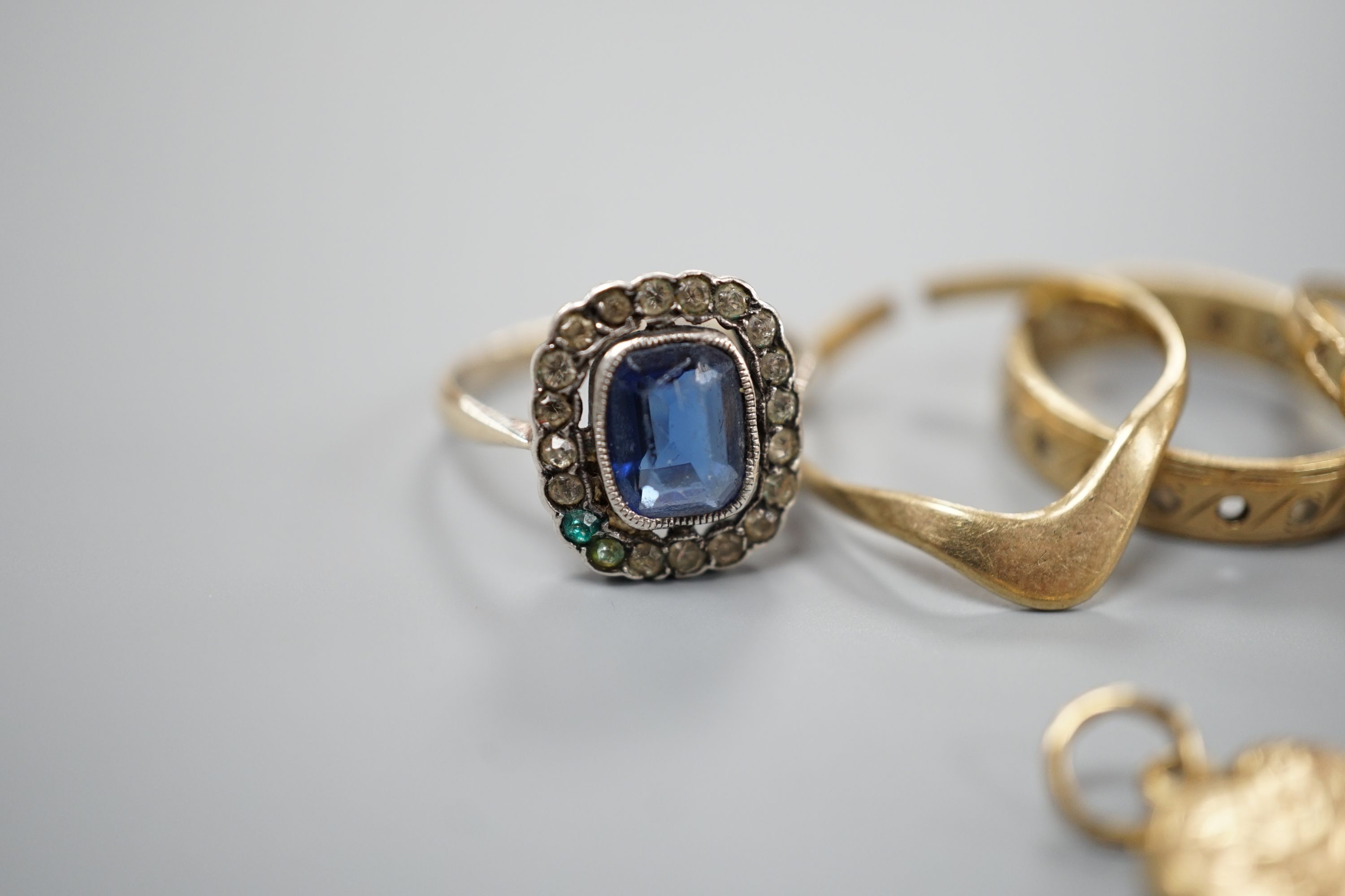 Four assorted 9ct gold rings, a 9ct gold heart pendant and a 9ct and paste set ring, gross 8.3 grams, an Edwardian 18ct gold ring, 4.4 grams and a yellow metal ring, 4 grams.